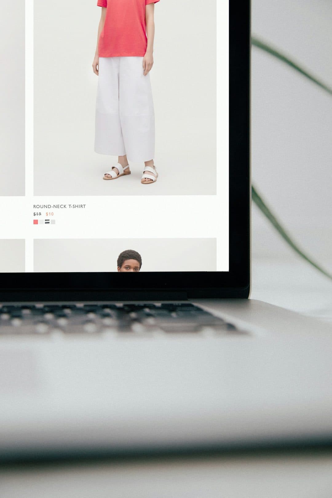 A premium fashion storefront viewed on a laptop